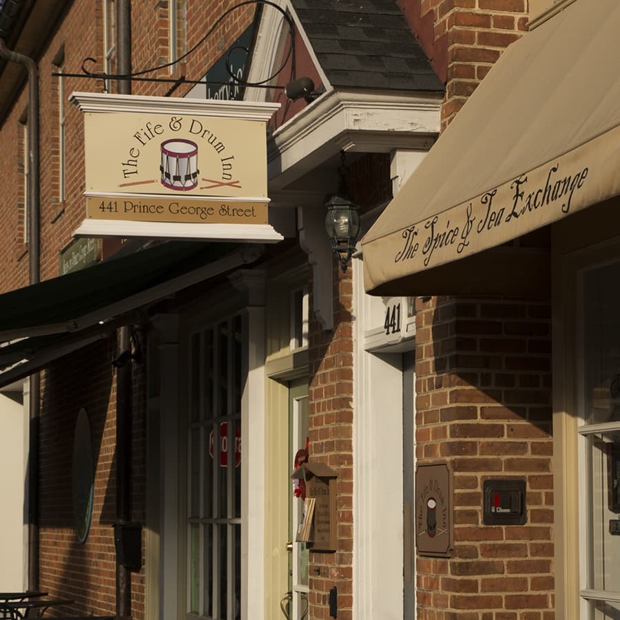 Exterior of Fife and Drum brick building with hanging sign