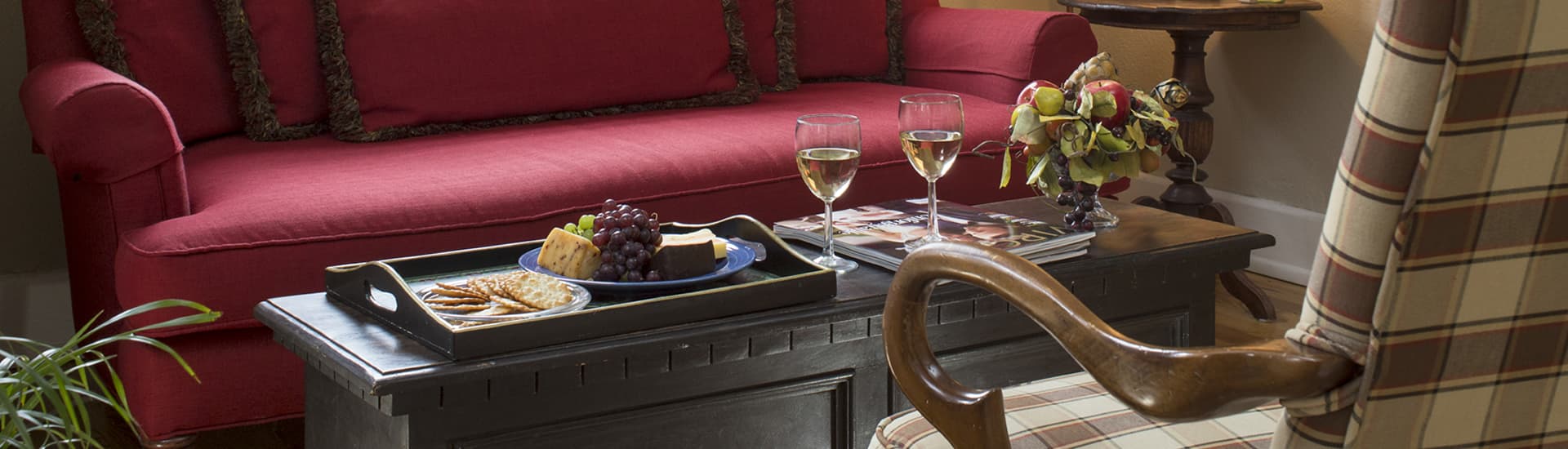 Sitting Room Photo with coffee table holding flowers and wine glasses